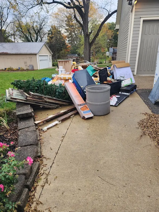 Dumpster being loaded with debris for Residential Dumpster Rental in Livermore Falls